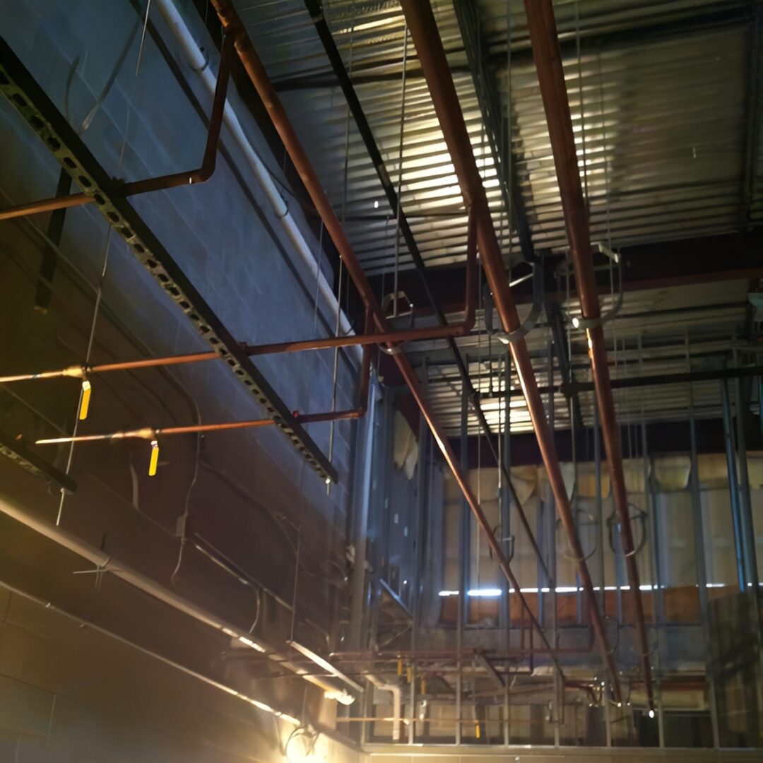 Industrial ceiling with metal pipes and beams.
